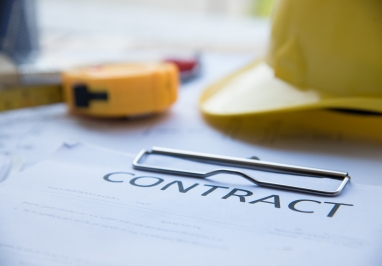 Image of construction contract and hard hat