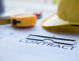 Image of construction contract and hard hat