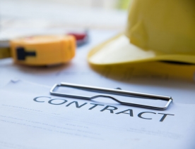 Image of construction contract and hard hat