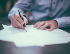 Person signing paper